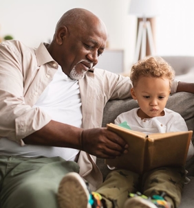 A grandfather and kid read together