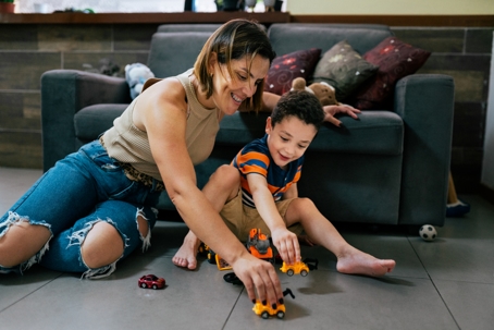 mother and son playing with toy cars