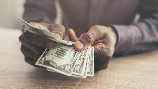 closeup of person counting money