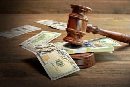 hundred dollar bills on gavel