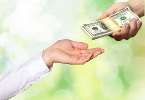 person handing money to somebody else