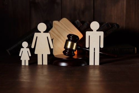 wooden cutout of family with a gavel