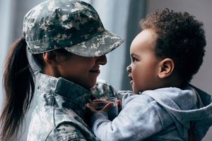 female military solider with their child