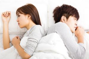 couple fighting in bed