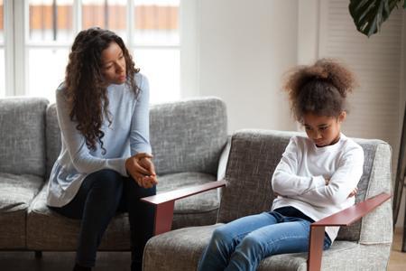 daughter sitting and looking angry with their mom