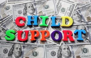 child support written in children font on top of money